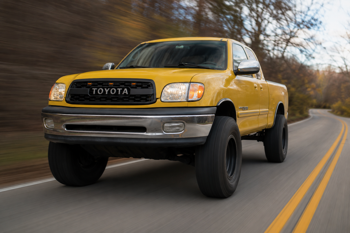 Yellow 1st Gen Tundra with TRD style grille, driving view