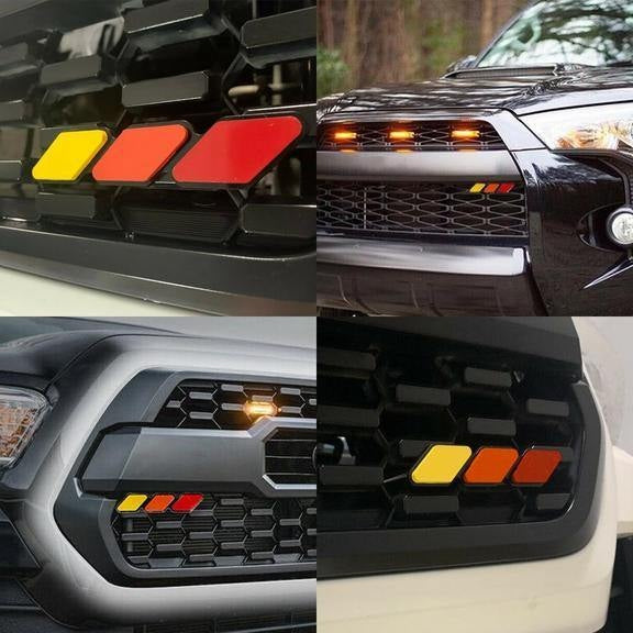 Red, orange and yellow retro grille badge shown mounted on four Toyota grilles