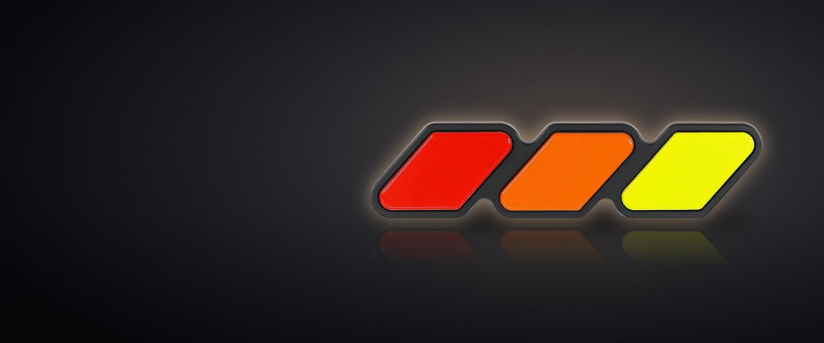 Red, orange and yellow retro grille badge on a dark studio background