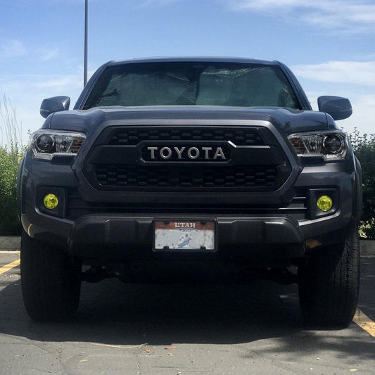 Dark gray 3rd Gen Toyota Tacoma with the TRD Pro style grille installed, front view